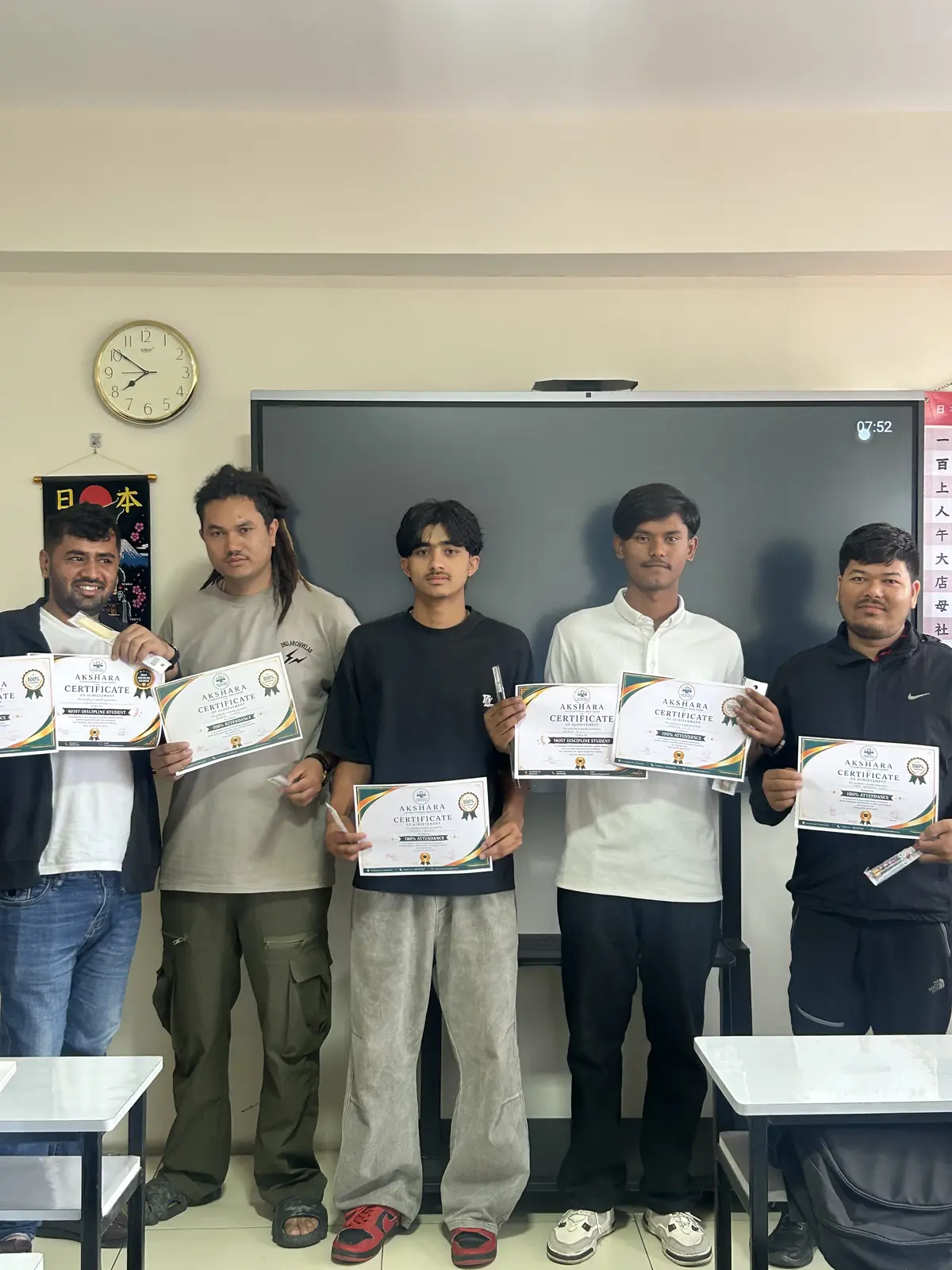 Students with their Japanese course completion certificates