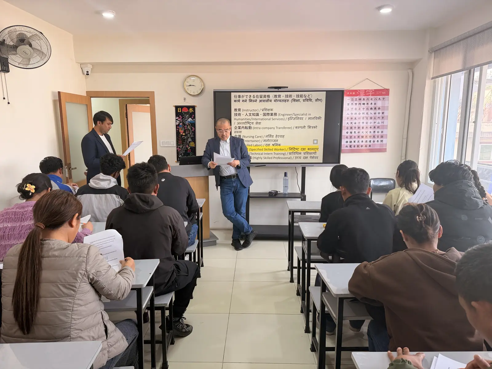 Instructor leading a Japanese lesson at the whiteboard
