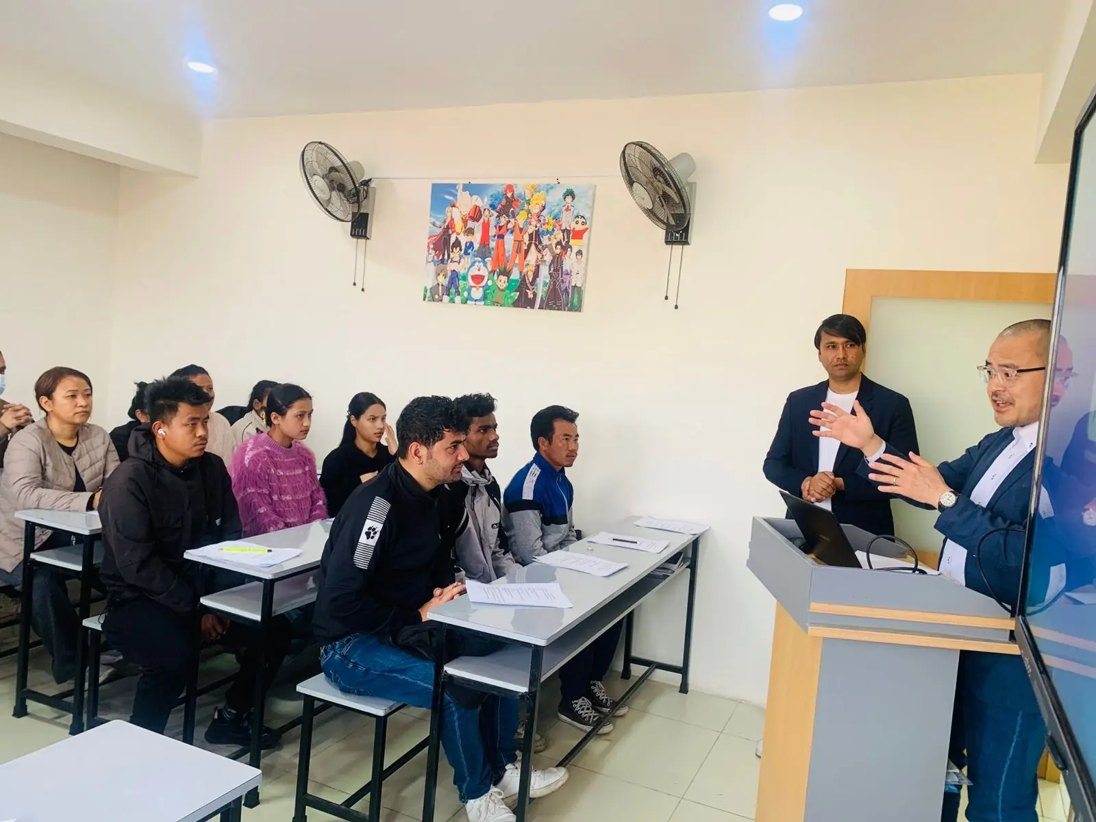 Representatives from a Japanese school presenting to students at Akshara