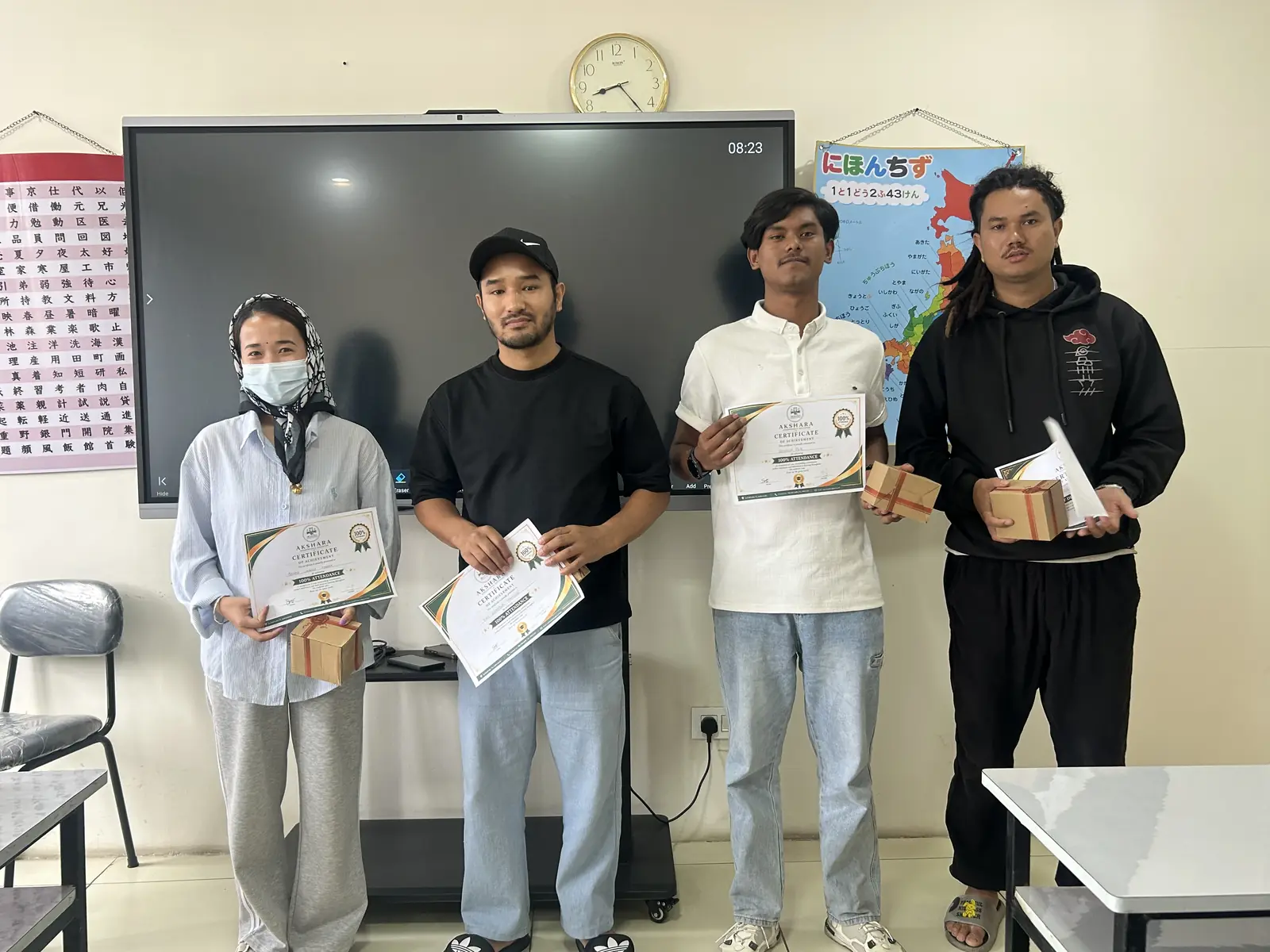 Students receiving Japanese test certificates in class