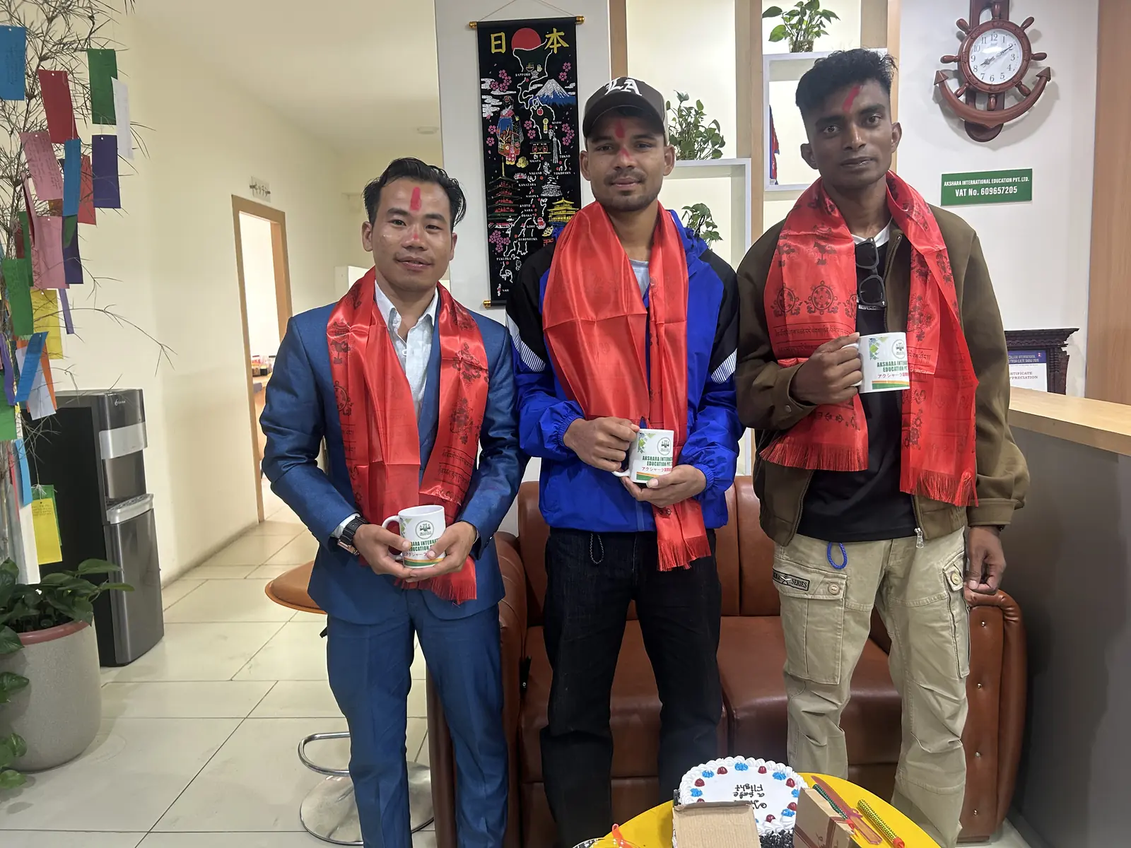 Students with traditional farewell scarves before leaving for Japan
