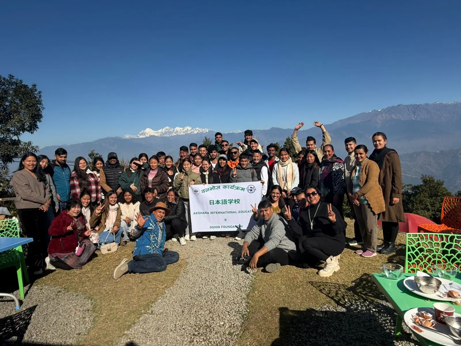 Akshara International Education students on a group trip with snow-capped mountains behind them